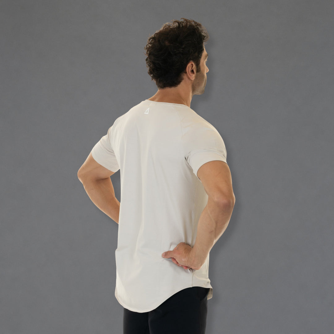 A man wearing a white athletic t-shirt, shown from the back and side against a solid gray studio background.