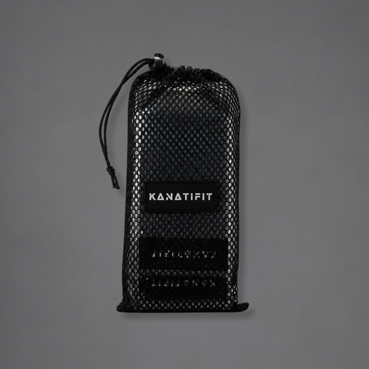 A black mesh drawstring pouch with a black label reading 'KANATIFIT' in white, photographed against a plain gray background.