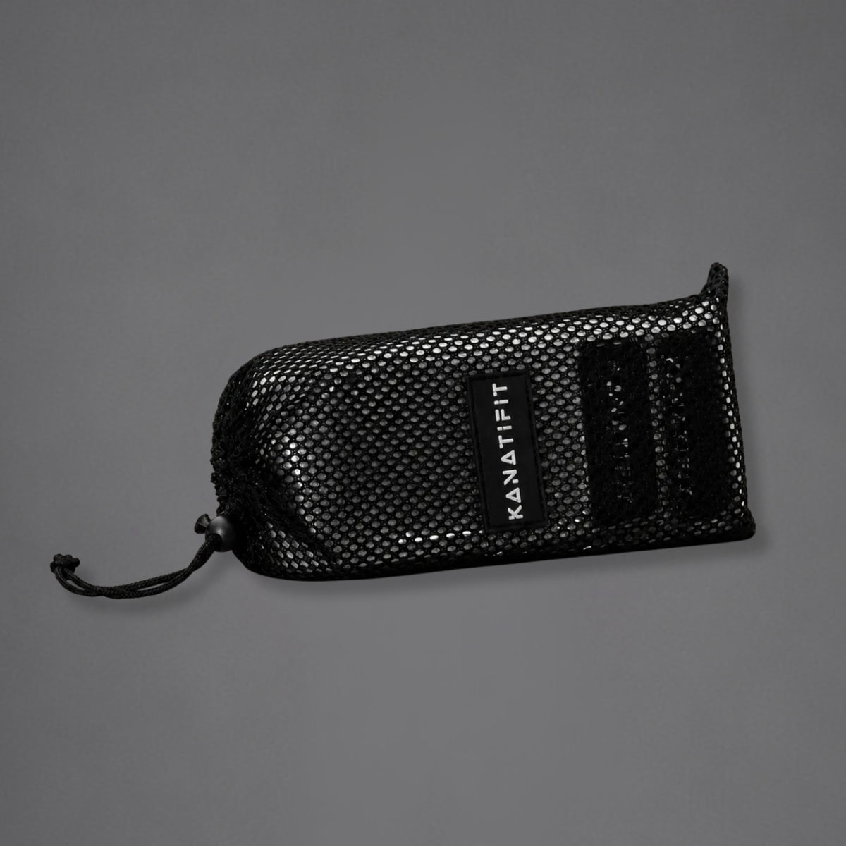 A black mesh drawstring pouch with a black label reading 'KANATIFIT' on a plain gray background.