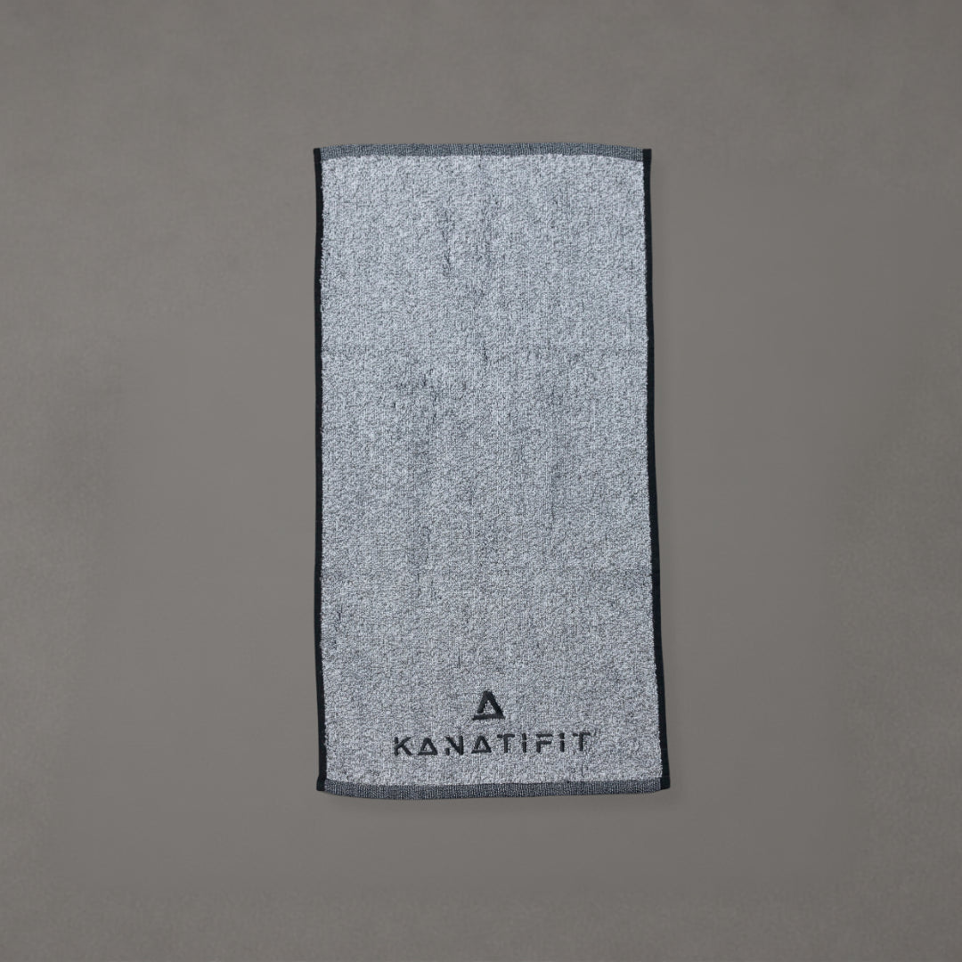 A gray textured towel with a dark gray border and the brand name 'KANATIFIT' printed at the bottom, displayed flat against a solid gray background.
